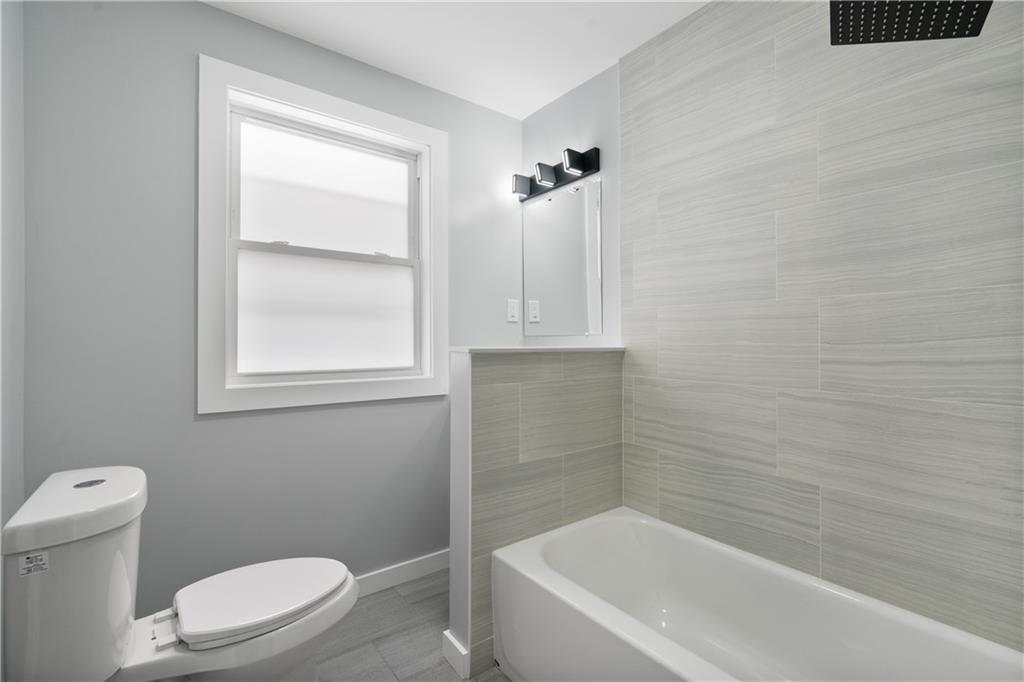 3030 Shady Avenue Pittsburgh, PA 15217 - Photo 17 of 31 a white toilet sitting next to a bath tub