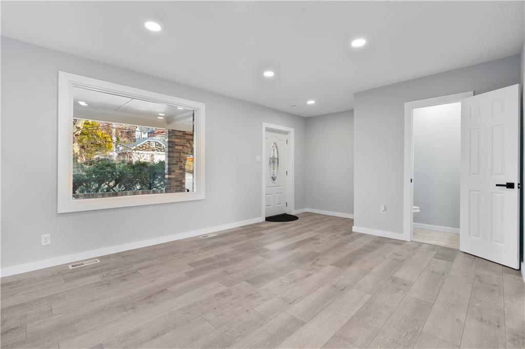 3030 Shady Avenue Pittsburgh, PA 15217 - Photo 21 of 31 an empty room with wooden floor and windows