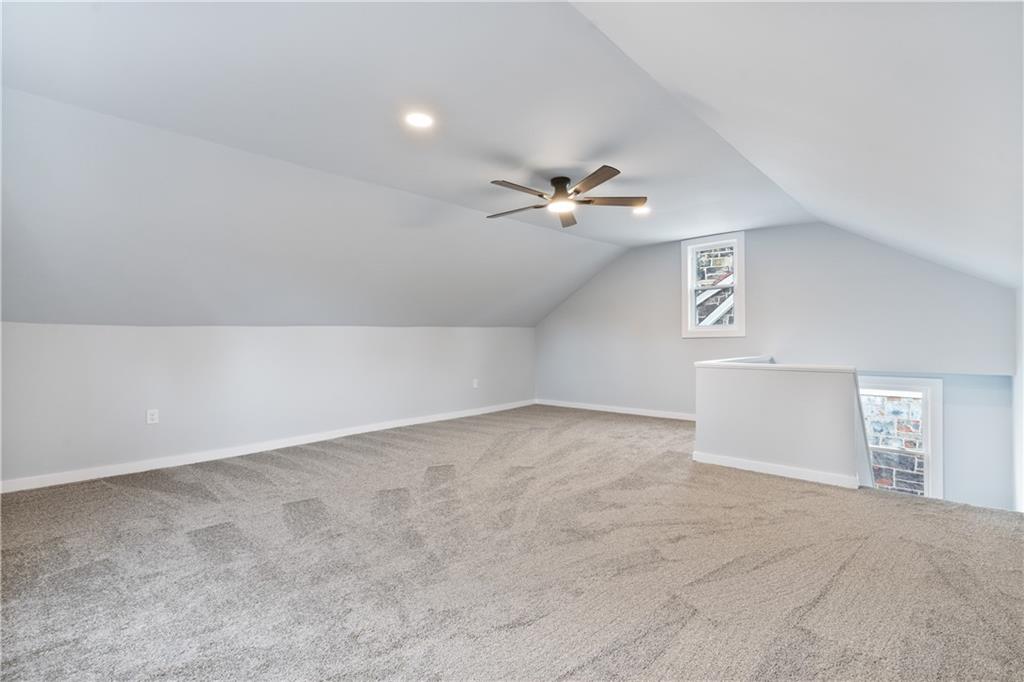 3030 Shady Avenue Pittsburgh, PA 15217 - Photo 23 of 31 an empty room with a chandelier fan and windows