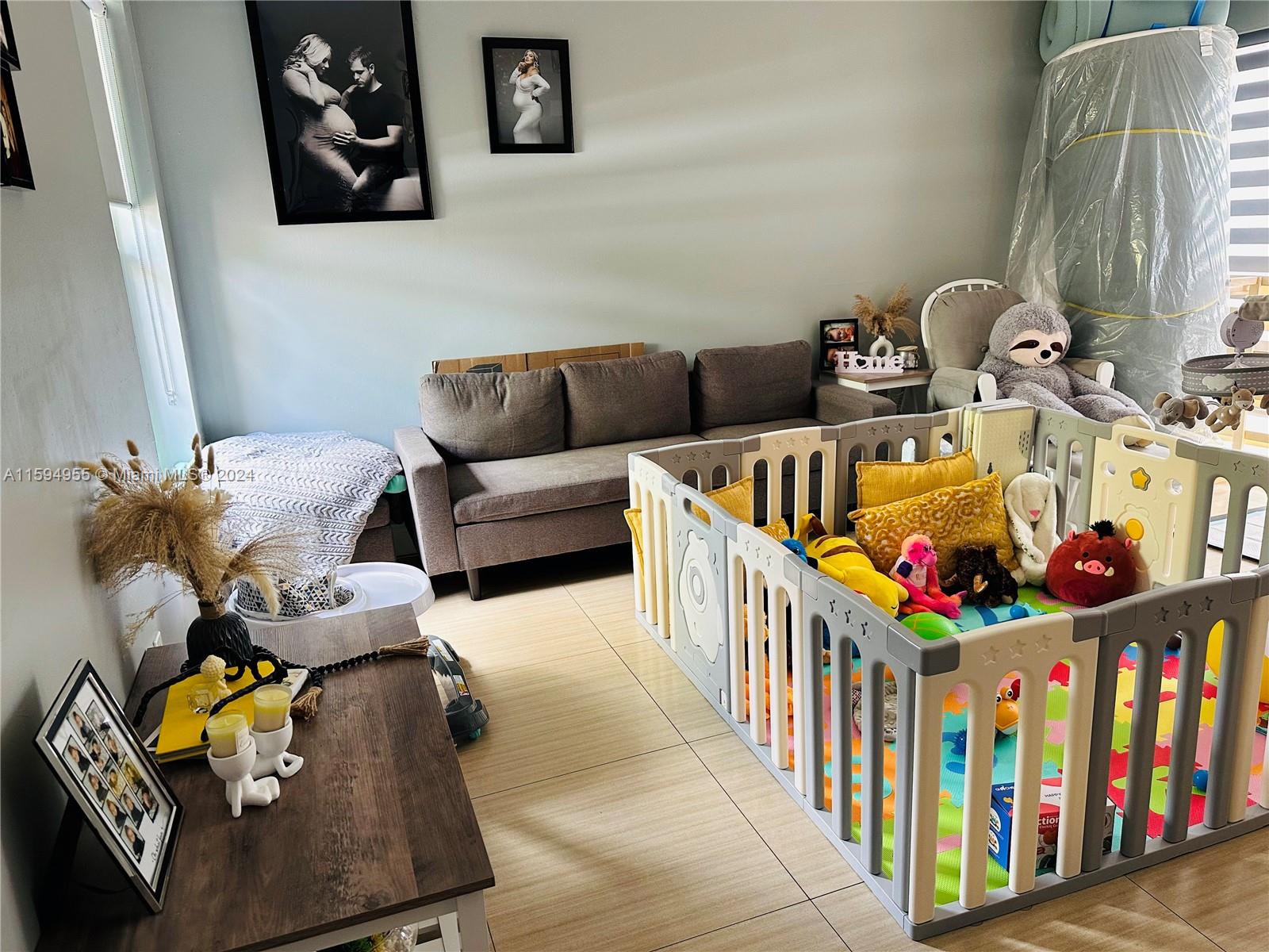 15056 Southwest 127th Place Miami, FL 33186 - Photo 3 of 25 a living room with lots of baby furniture