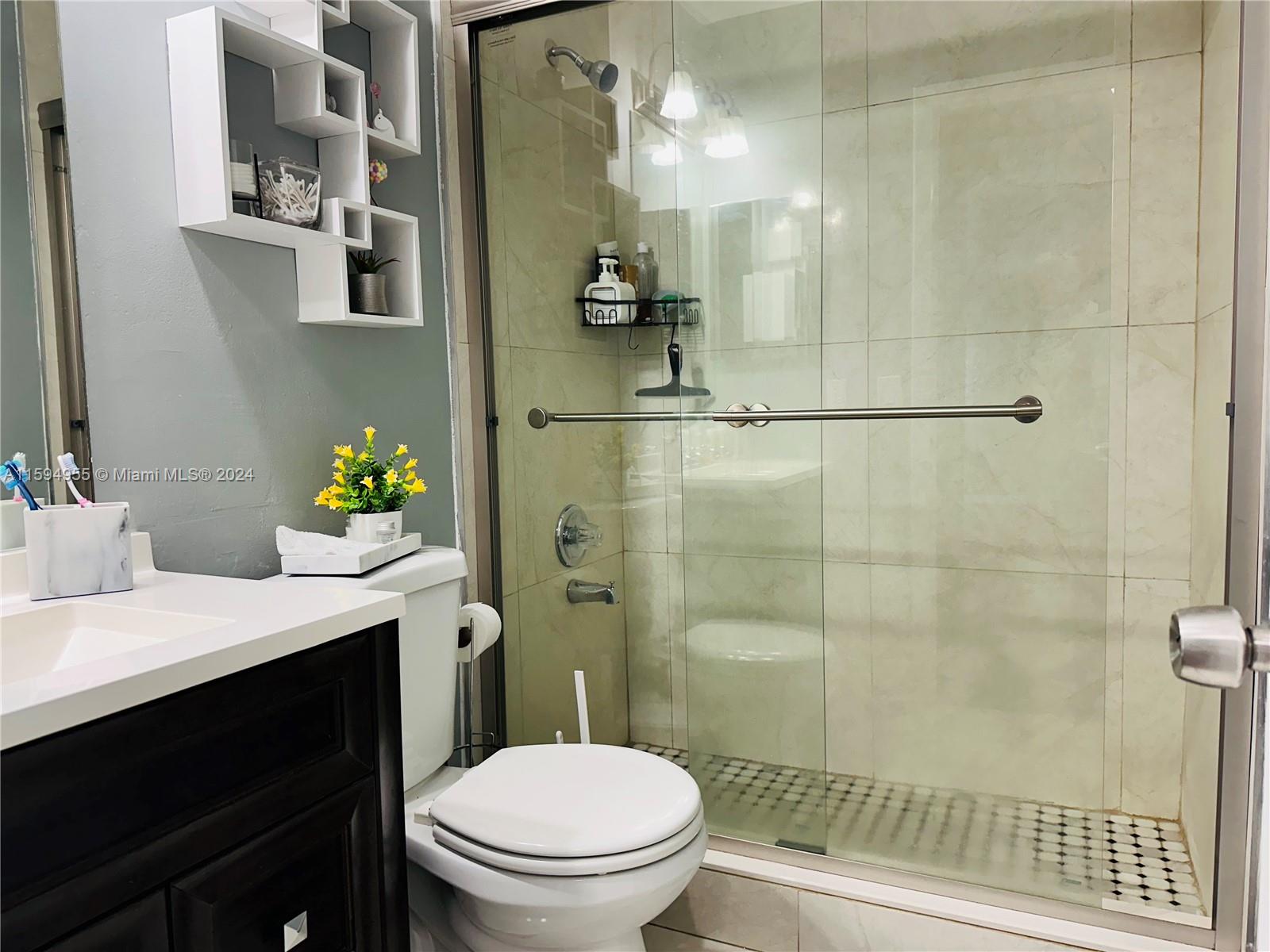 15056 Southwest 127th Place Miami, FL 33186 - Photo 6 of 25 a bathroom with a sink a toilet and shower