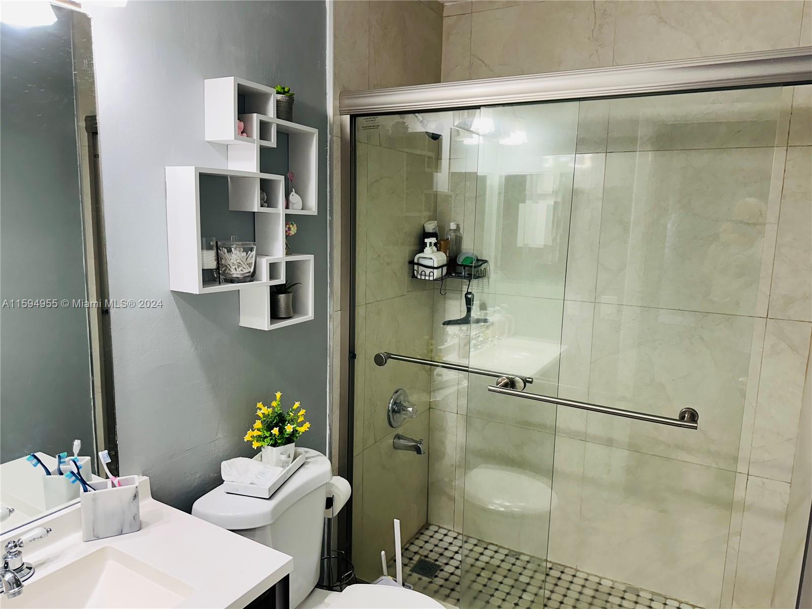 15056 Southwest 127th Place Miami, FL 33186 - Photo 7 of 25 a bathroom with a sink toilet and shower