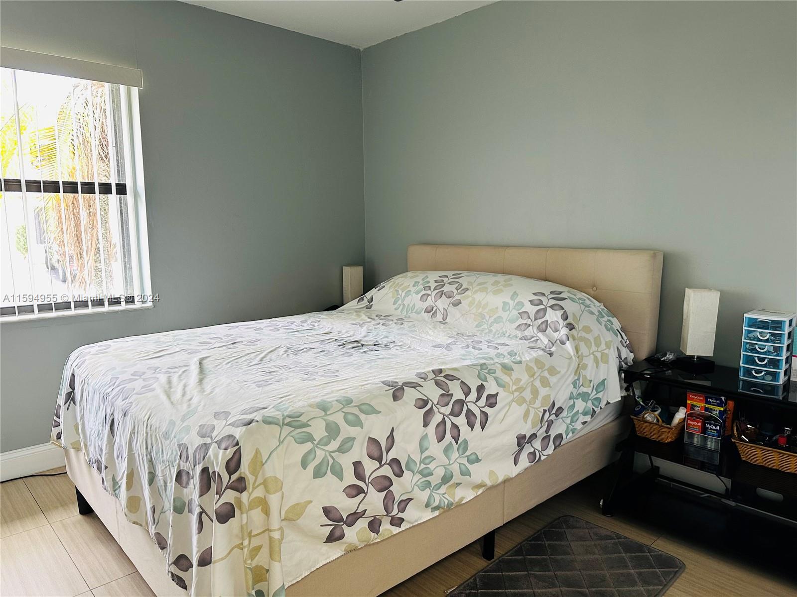 15056 Southwest 127th Place Miami, FL 33186 - Photo 8 of 25 a bed sitting in a bedroom next to a window