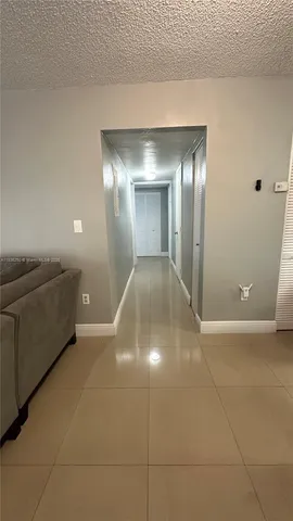 a view of a livingroom with wooden floor and staircase