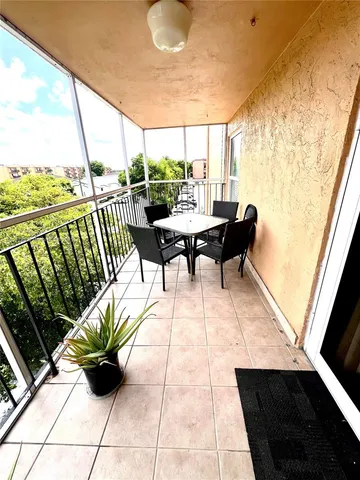 a living room with a table and chairs