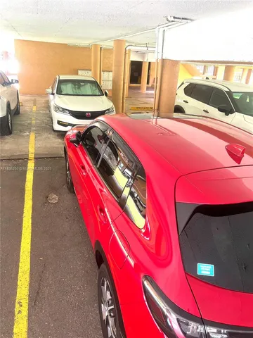 a utility room with stainless steel appliances lots of white furniture and a large window