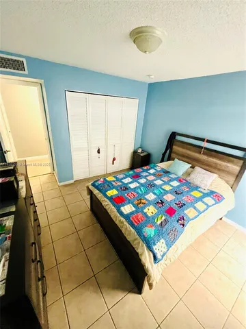 a bedroom with a bed and a coffee table