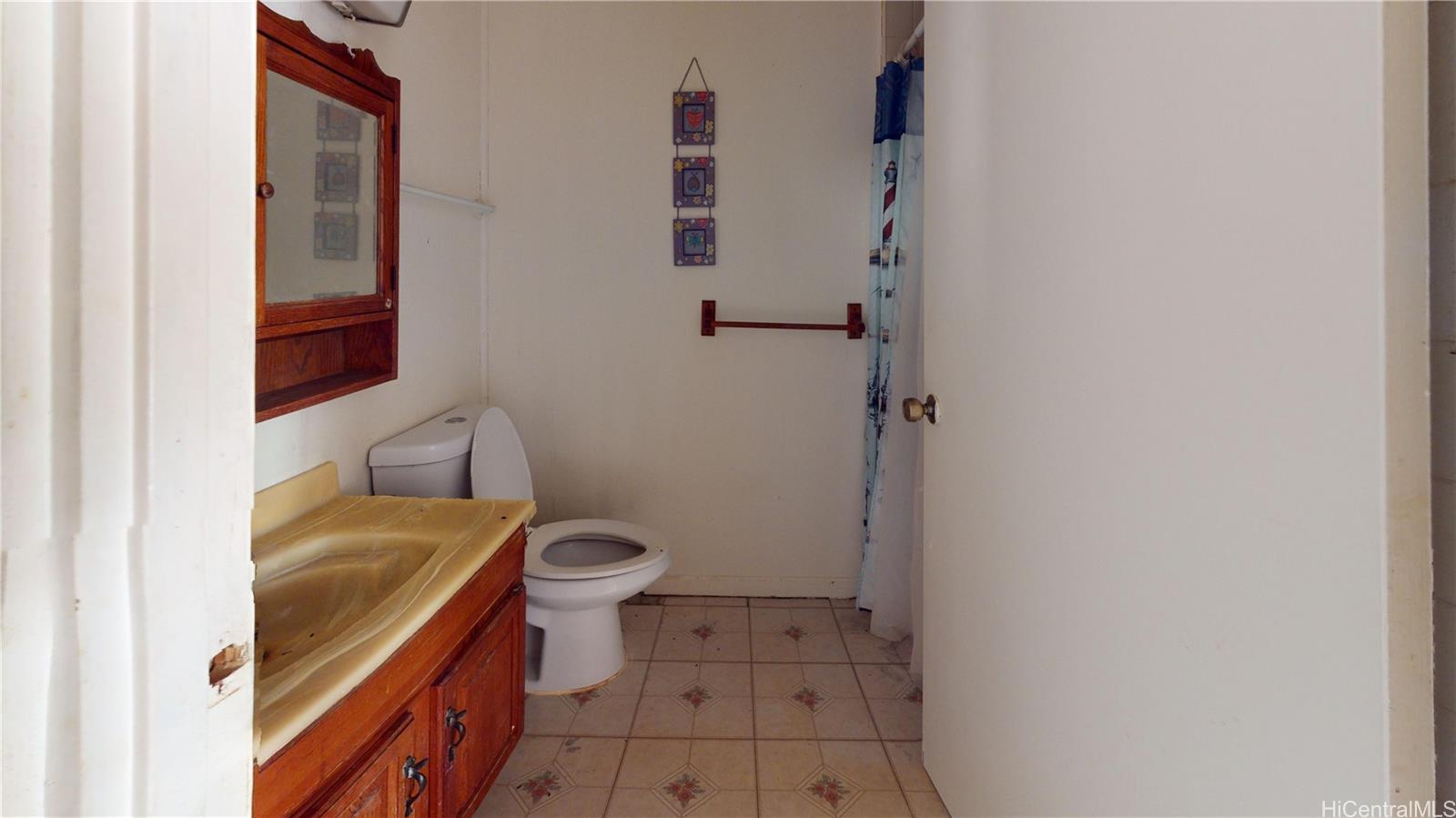 85-128 Ala Walua Street, Unit B Waianae, HI 96792 - Photo 7 of 16 a bathroom with a sink and a toilet