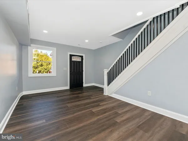 a view of an entryway with wooden floor
