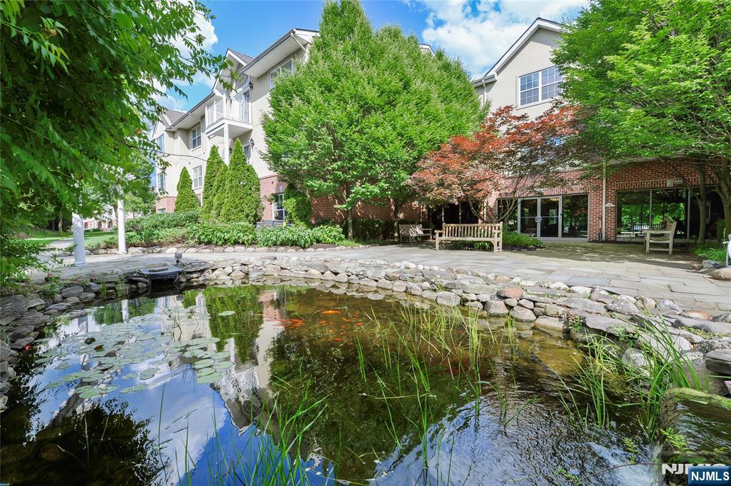121 Courter Road, Unit 82 Franklin Lakes, NJ 07417 - Photo 2 of 7 a swimming pool with outdoor seating and trees