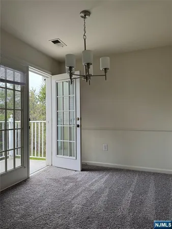 a view of a room with a empty space and windows