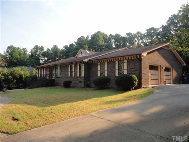 5005 Robinwood Road Durham, NC 27713 - Photo 1 of 6 a view of a house with a big yard and potted plants
