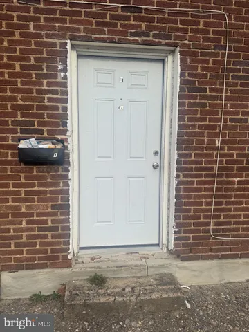 a front view of a residential apartment building with a yard