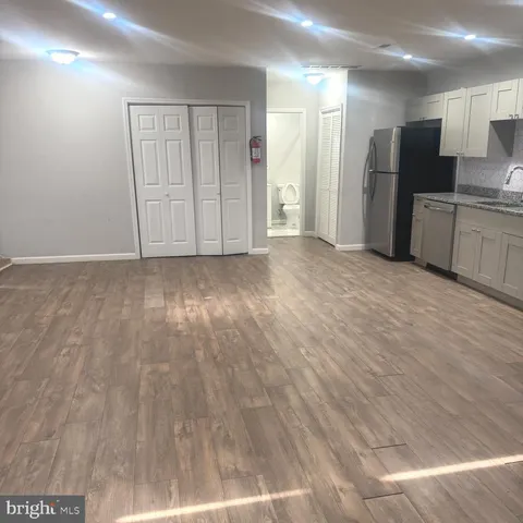 a view of a kitchen with a sink and a refrigerator