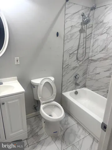 a white toilet sitting next to a bathroom sink