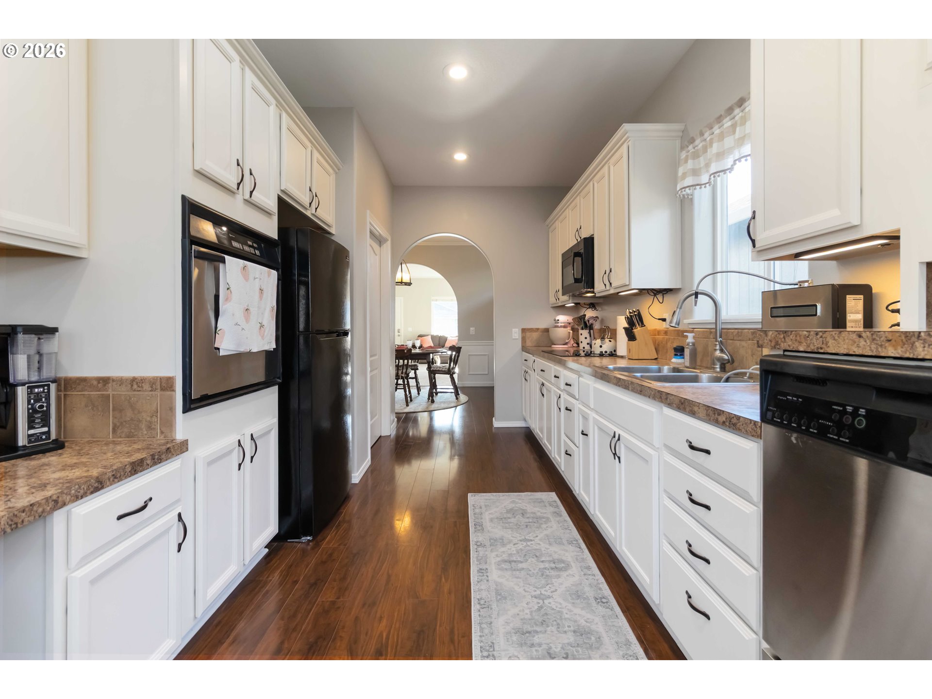 5558 Solo Point Drive Longview, WA 98632 - Photo 18 of 40 a large kitchen with stainless steel appliances granite countertop a lot of counter space and wooden floors