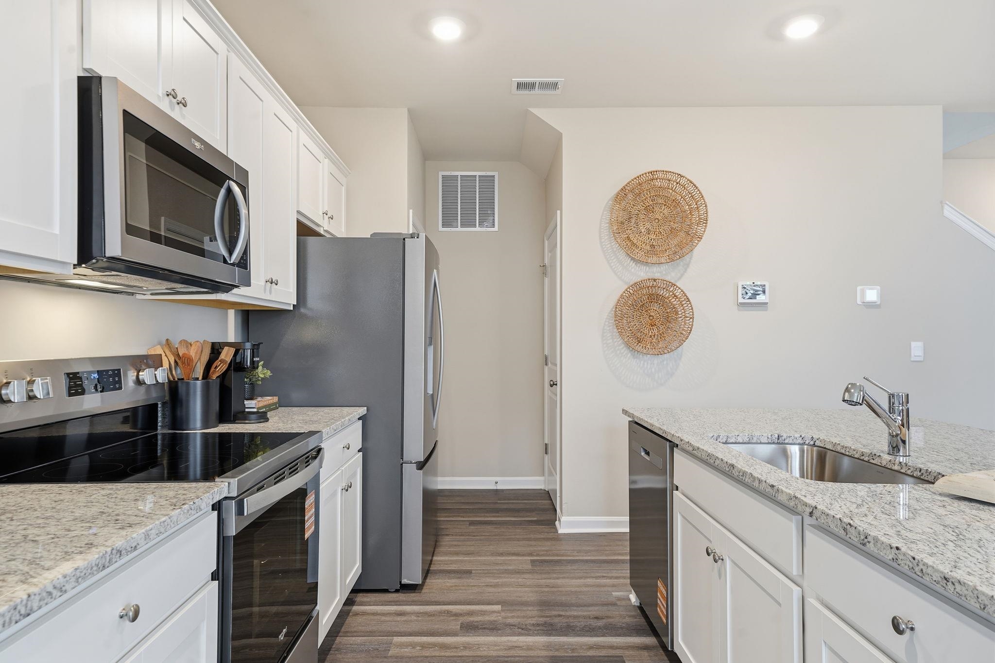 109 Meadow Ridge Way Staunton, VA 24401 - Photo 5 of 29 a kitchen with stainless steel appliances granite countertop a sink a stove top oven and microwave