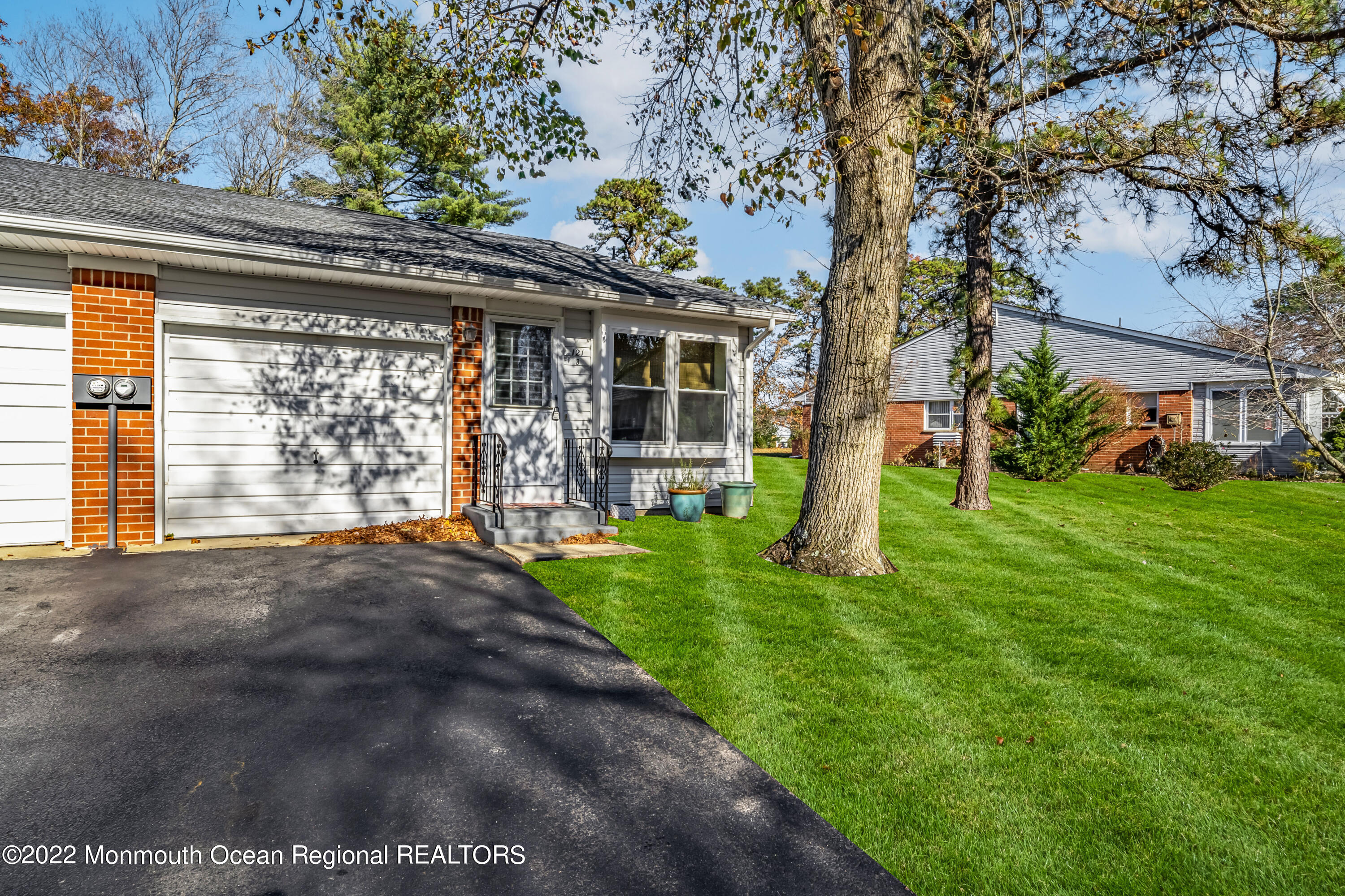 121 Constitution Boulevard, Unit B Whiting, NJ 08759 - Photo 2 of 20 a front view of a house with garden
