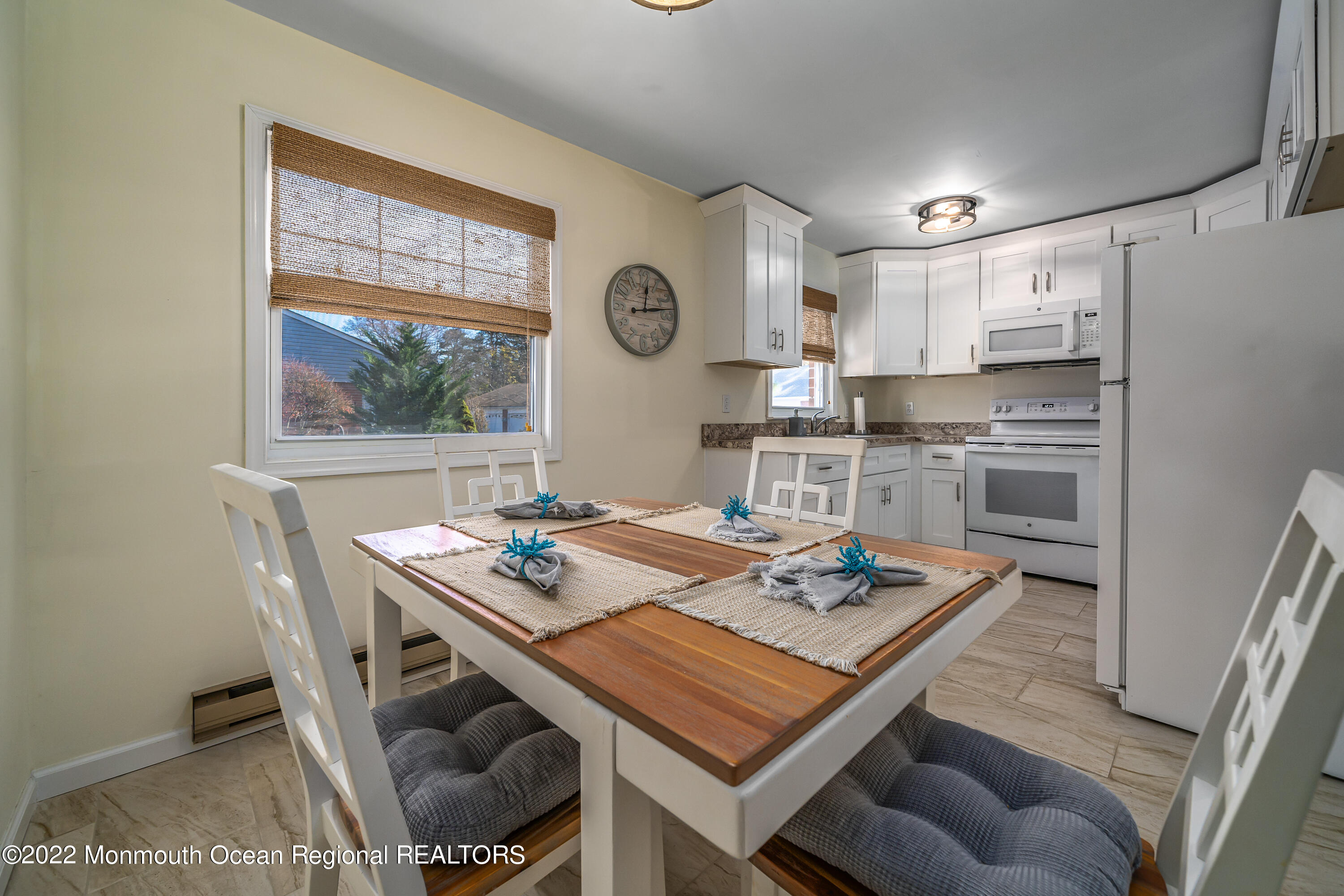 121 Constitution Boulevard, Unit B Whiting, NJ 08759 - Photo 7 of 20 a view of kitchen with kitchen island stainless steel appliances sink stove and dining table