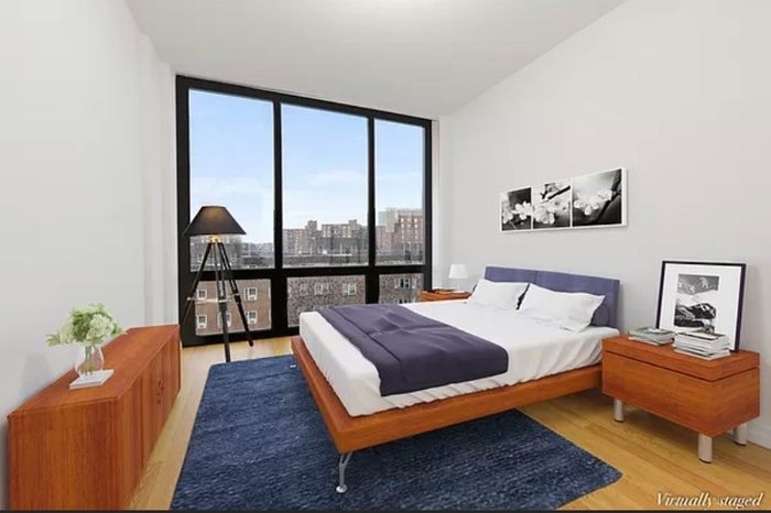 63-36 99th Street, Unit 8E Queens, NY 11374 - Photo 7 of 19 a bedroom with a bed and a large window