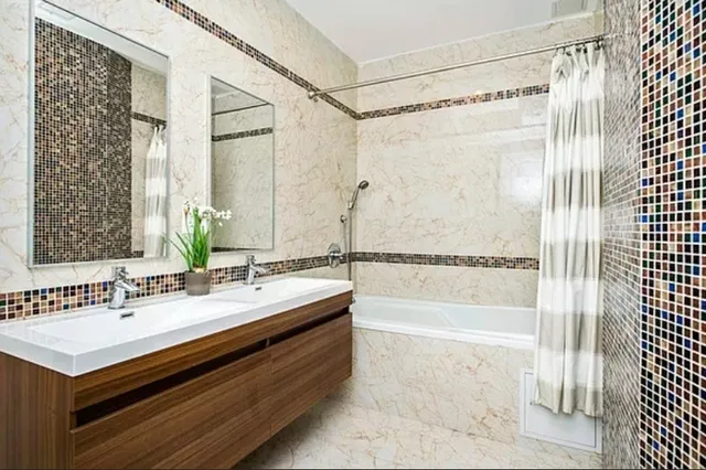 a bathroom with a sink a mirror and a shower