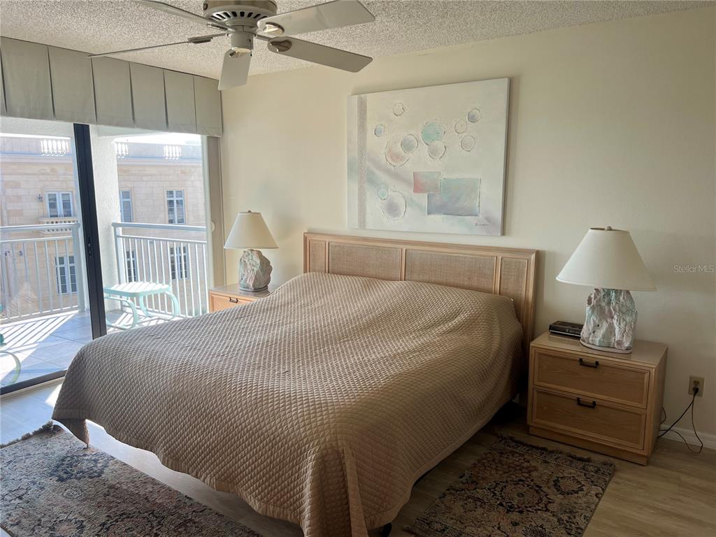 1001 Point Of Rocks Road, Unit 508 Sarasota, FL 34242 - Photo 11 of 34 a bedroom with a bed and a painting on the wall