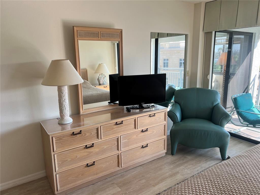 1001 Point Of Rocks Road, Unit 508 Sarasota, FL 34242 - Photo 12 of 34 a living room with furniture and a flat screen tv