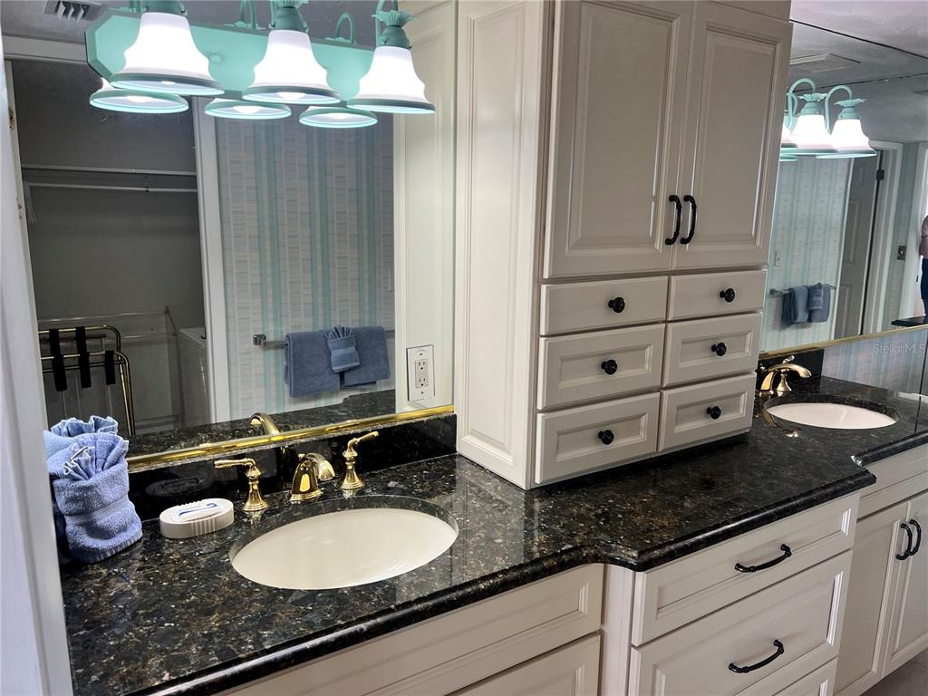 1001 Point Of Rocks Road, Unit 508 Sarasota, FL 34242 - Photo 13 of 34 a bathroom with a granite countertop double vanity sink and mirror
