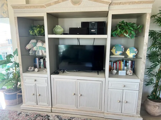a room with a fireplace and potted plant