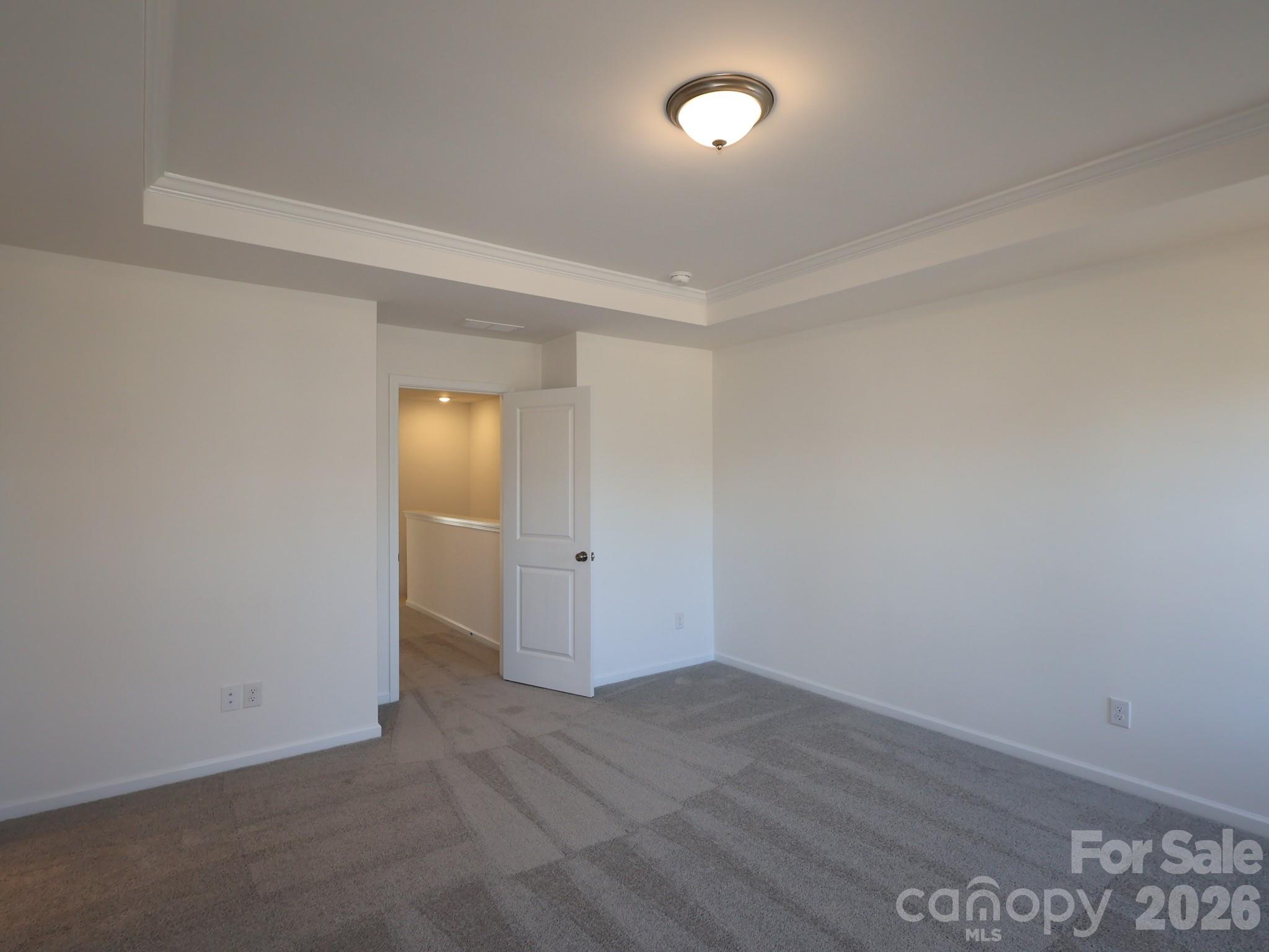 1152 Overbrook Place Wingate, NC 28174 - Photo 16 of 19 an empty room with wooden floor and mirror