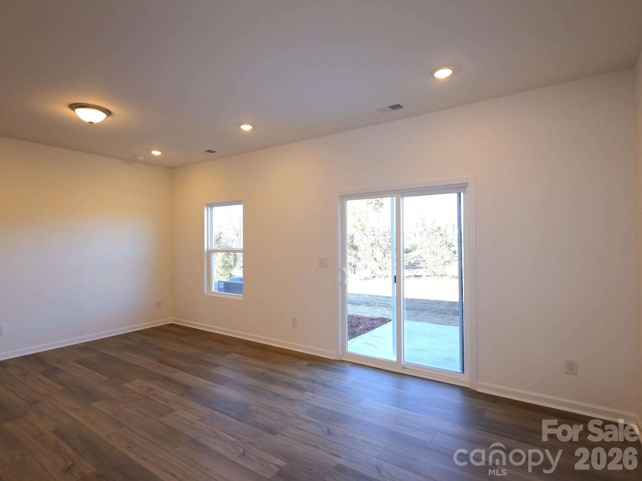 1152 Overbrook Place Wingate, NC 28174 - Photo 7 of 19 an empty room with wooden floor and windows