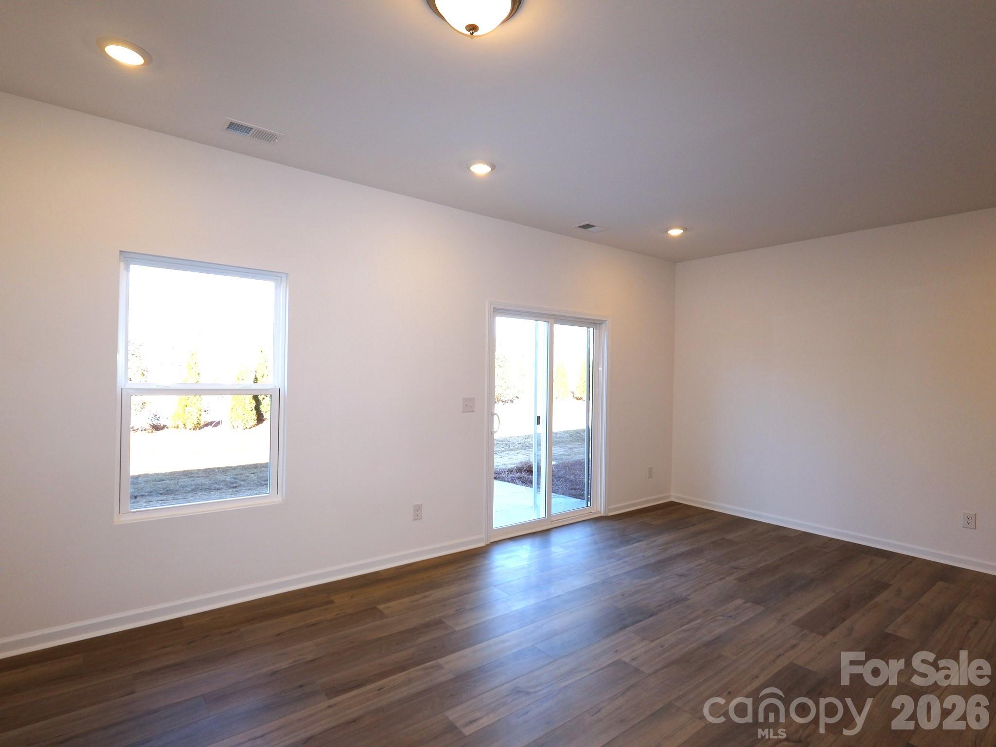 1152 Overbrook Place Wingate, NC 28174 - Photo 8 of 19 a view of an empty room with wooden floor and a window