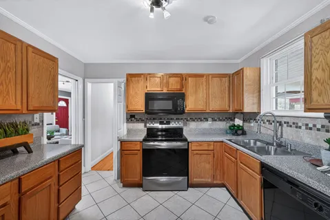 a kitchen with stainless steel appliances a stove sink and cabinets