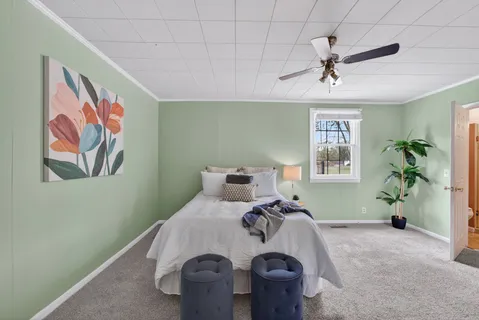 a bed room with furniture and window