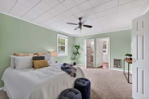 a bedroom with bed and wooden floor