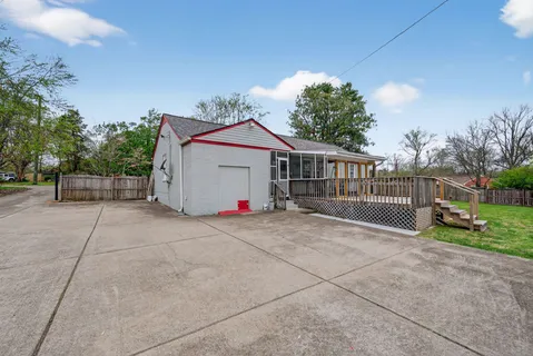 a view of backyard with deck and garden