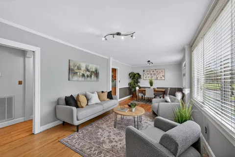 a living room with furniture a rug and a window