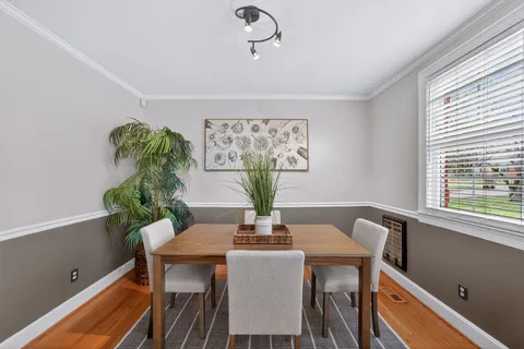 a dining room with furniture and window