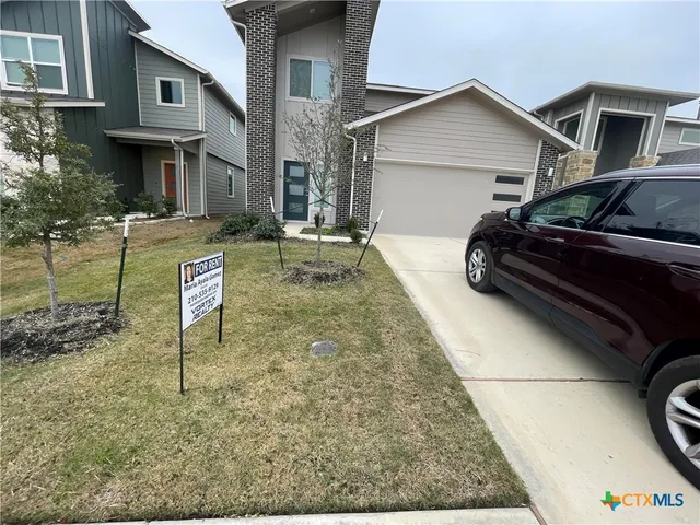 a view of a car park in front of house