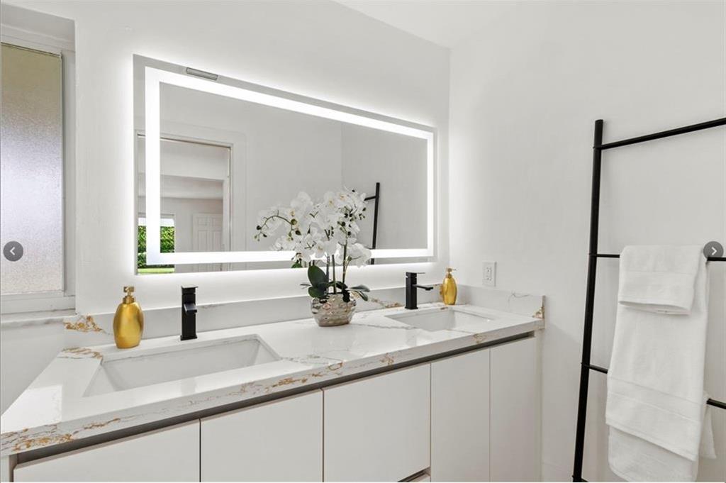 1365 Southwest 14th Street Boca Raton, FL 33486 - Photo 6 of 12 a bathroom with a sink and a mirror