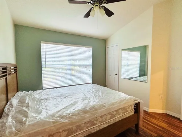 a bedroom with a bed and a window