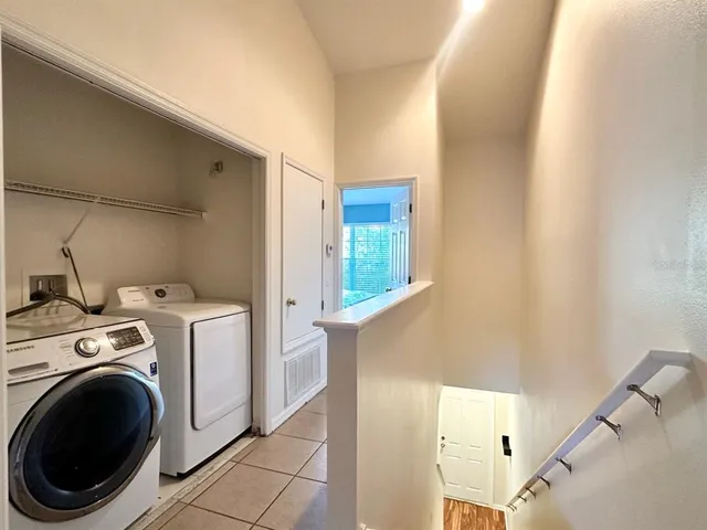 a view of washer and dryer with kitchen in the background