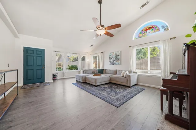 a living room with furniture a fireplace and a chandelier