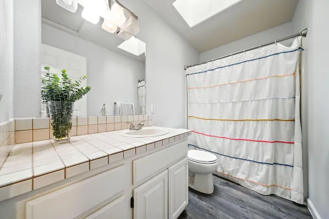 a bedroom with furniture and a ceiling fan