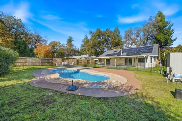a view of a swimming pool with an outdoor space and seating area