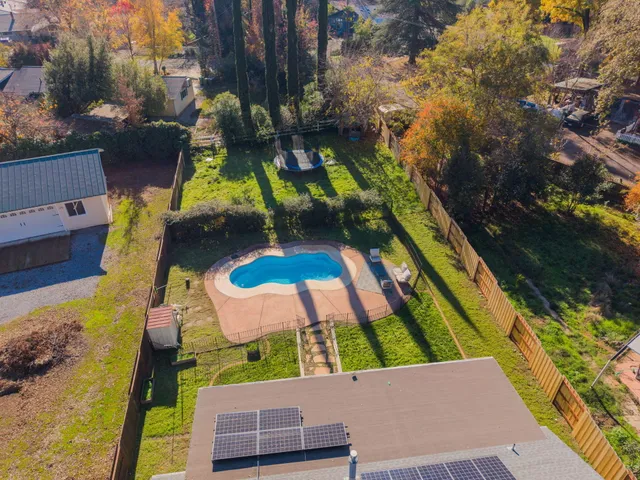 a backyard of a house with lots of green space and fountain