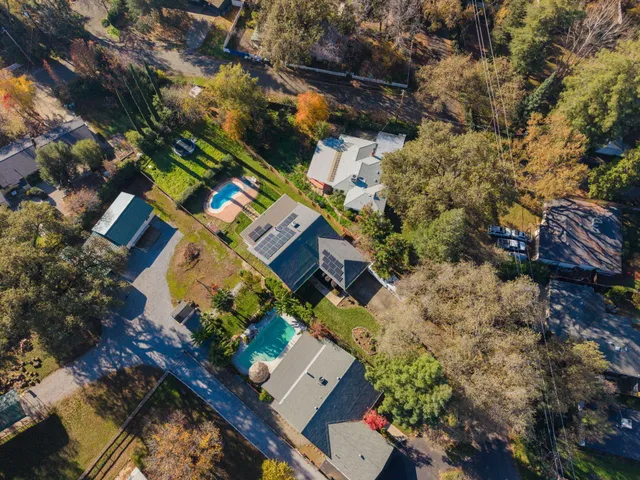 an aerial view of residential houses with outdoor space