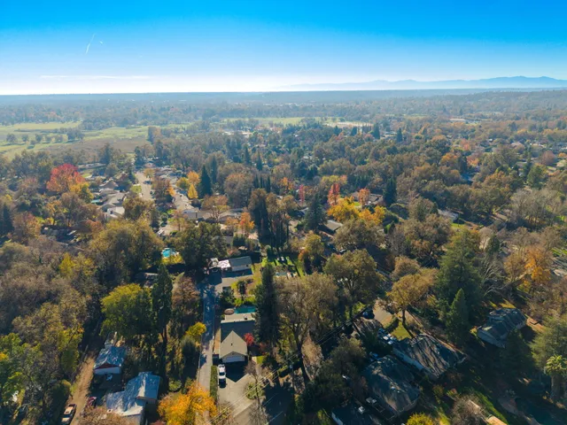 an aerial view of a house with a yard