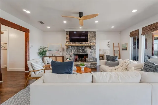 a living room with fireplace furniture and a flat screen tv