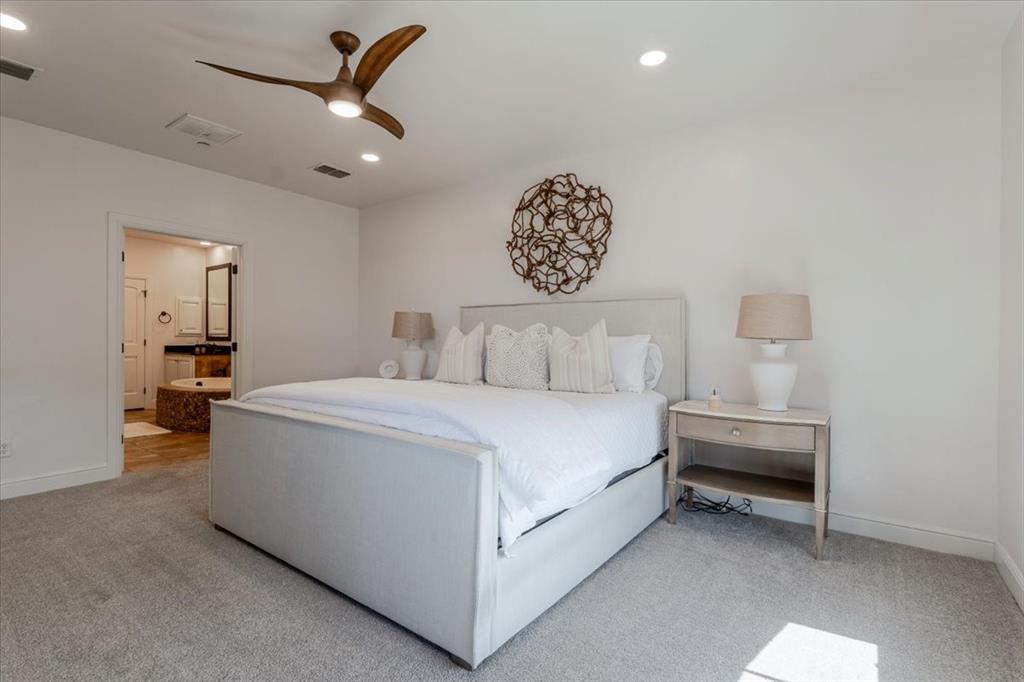 1653 Scenic Drive, Unit 102 Graford, TX 76449 - Photo 14 of 40 a bedroom with a bed and a chandelier